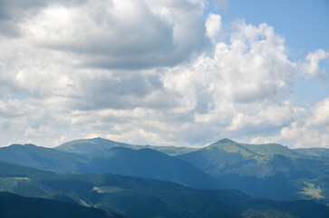 Chornohora mountain range with mount Pip Ivan with the ruins of the observatory on top under a low cloudy sky. Carpathian Mountains, Ukraine