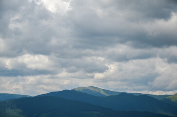 Chornohora mountain range with mount Pip Ivan with the ruins of the observatory on top under a low...