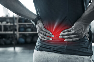 Man, fitness and back pain with red glow at gym with muscle tension at sports center. Male person, workout and exercise with ache, injury and inflammation on training or warm up for wellbeing