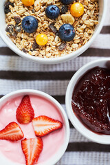 Above, breakfast and cloth in hotel with food, fresh fruit and spread for croissant. Hospitality, meal and room service in luxury accommodation for nutrition, healthy brunch and serving in morning