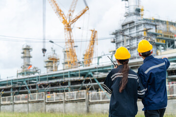 Man and woman petrochemical engineer teamwork meeting discussion at petroleum oil refinery industry...