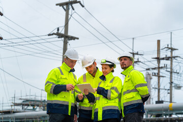 Group of Petrochemical engineers teamwork working together at petroleum oil refinery industry area....