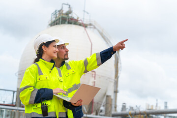 Man and woman petrochemical engineer teamwork meeting discussion at petroleum oil refinery industry...