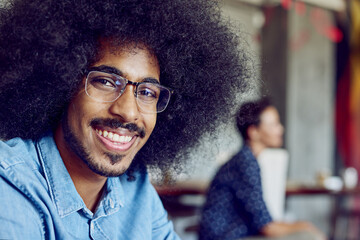 Fototapeta premium Happy, startup and portrait of businessman in office with pride, confidence and smile in workplace. Creative company, professional worker and person for coworking, web design agency and working
