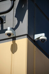 Security Cameras on Building Corner with Strong Shadows in Urban Setting