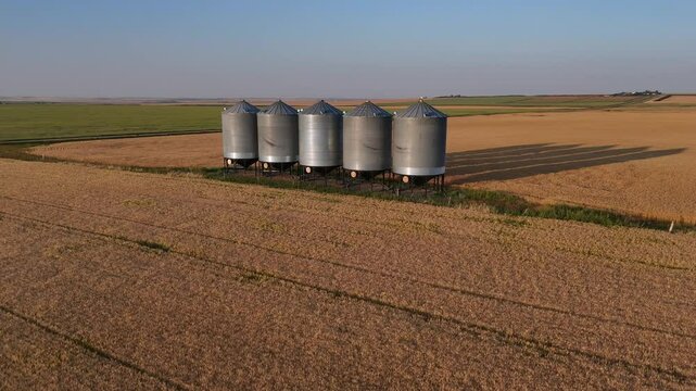 Grain Silos aerial shot during golden hour along the Canadian prairies in Kneehill County Alberta Canada.
