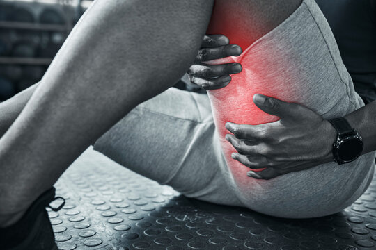 Hand, person and thigh pain from fitness injury with overlay, exercise accident and hamstring risk of tendinitis. Athlete, legs and red glow for performance fail, muscle problem and sports emergency