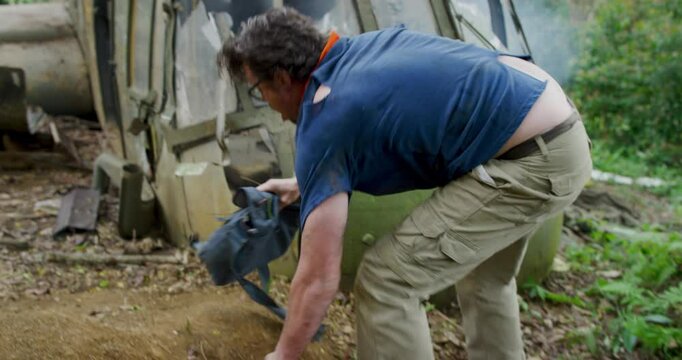 Man surviving helicopter crash and struggling through forest - steady cam