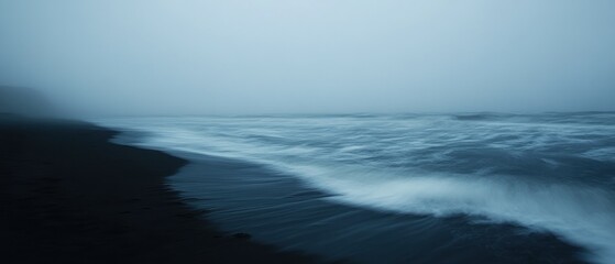 Black Sand Beach with Blurry Waves in Fog