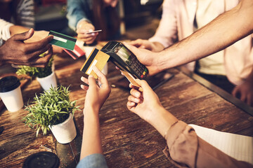 Hands, people and credit card for payment at cafe with online transaction, share bill and pos machine in top view. Waiter, friends and debit service with group at coffee shop for finance and banking