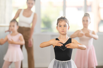 Ballet lesson for children - choreographer teaches girls ballet steps © JackF