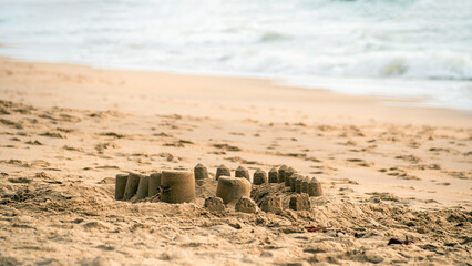 The small sand castles on the sandy beach