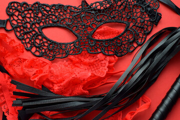 Erotic red stockings, black lace mask and leather whip for sex games. BDSM toys for role-playing...