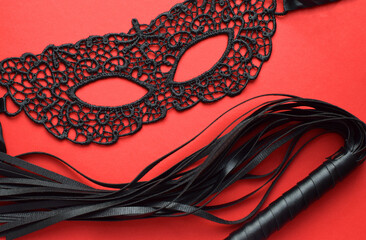 Erotic black lace mask and leather whip for sex games. BDSM toys for role-playing sex games.