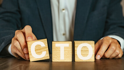 There is wood cube with the word CTO. It is an abbreviation for Chief Technology Officer as...