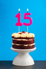 Red velvet birthday cake with number 15 candle