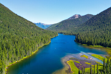 Fototapeta premium Cooper lake with mountain landscape. Landscape of mountain and forest of Cooper lake. Nature landscape. Cooper Lake in Washington. Scenic nature of popular hiking Cooper lake. Charming scenery