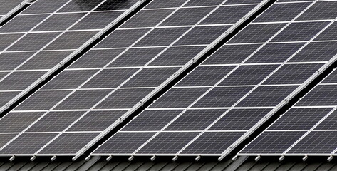 close up of solar panels on rooftop of building in France. Renewable energy for electricity with...