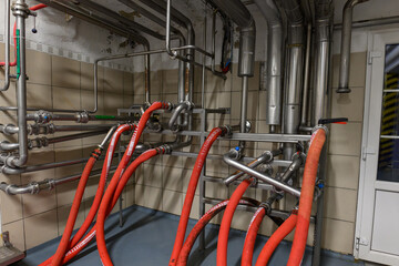Hoses connected to stainless steel pipes in the food industry.