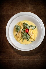 Burrata tortelli with Sicilian lemon on a plate seen from above