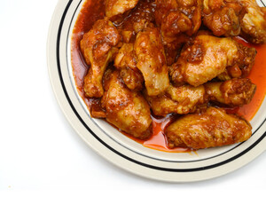 Chicken wings with sauce on white background