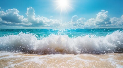 Fototapeta premium Stunning view of ocean waves crashing on a sandy beach under a bright sun and blue sky with fluffy clouds.