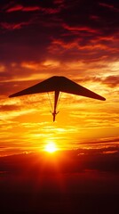 A silhouette of a hang glider against a stunning sunset, capturing the thrill of flight and freedom