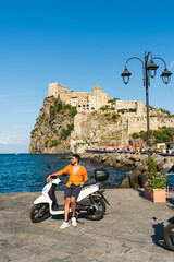 man riding a scooter in ischia italy summer