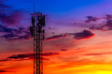 Telecommunication towers with colorful sky as a backdrop in the morning and sunlight reflecting off clouds create a stunning and mesmerizing light effect. Concept of innovation, technology and environ