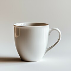 Fototapeta premium White Ceramic Mug with Rounded Handle on a White Background