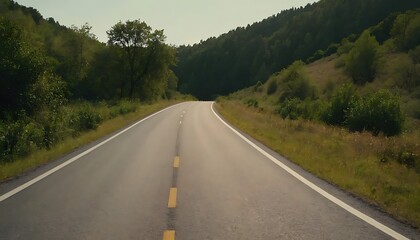 Fototapeta premium a long empty road with a white line on the side and a mountain in the background.13