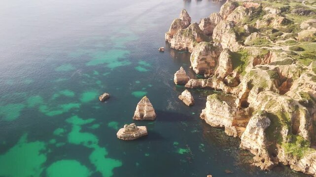 Aerial view of breathtaking Praia do Camilo with rugged cliffs and turquoise clear water, Lagos, Portugal.