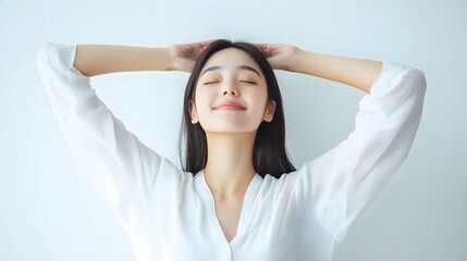 Naklejka premium Radiant Asian Woman Peacefully Stretching Arms on White Background