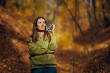Woman Suffering from Autumn Allergies Holding Inhaler. Unwell asthmatic person feeling sicker...