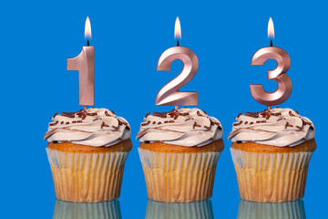 Birthday Cupcakes With Candles Lit Forming The Number 123.