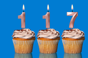 Birthday Cupcakes With Candles Lit Forming The Number 117.