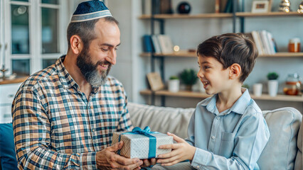 Obraz premium happy father and son with gift box looking at each other at home