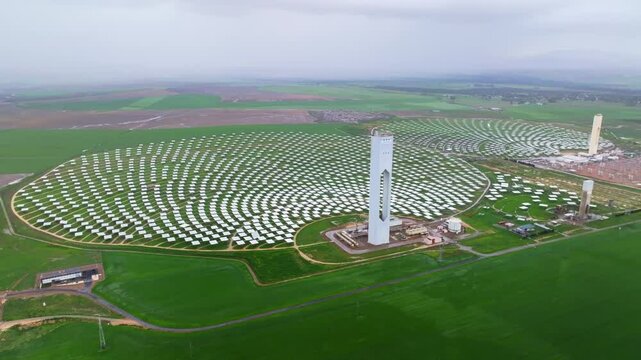 Aerial view of solar plant Abengoa Solar with solar panels and solar tower in a sunny landscape, Sanlucar la Mayor, Spain.