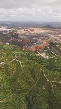Aerial view of beautiful mining terraces and lush vegetation in a scenic landscape, La Dehesa, Spain.