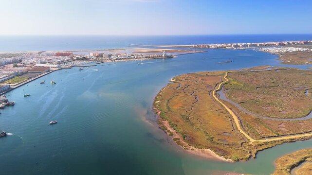 Aerial view of the picturesque port of Isla Cristina with serene marshland and vibrant boats, Isla Cristina, Spain.