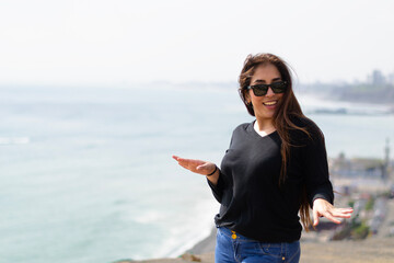 Portrait of latin woman in the sun with natural background, happy expression