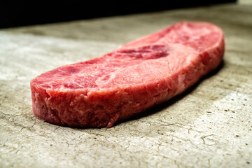 A piece of sirloin meat with a red center and a white spot