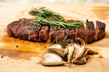 A piece of sirloin meat is cut and sitting on a wooden cutting board