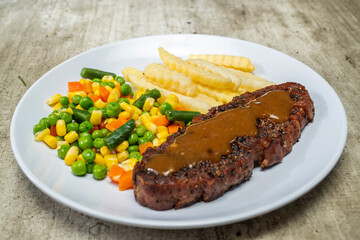A plate of food with a piece of sirloin meat