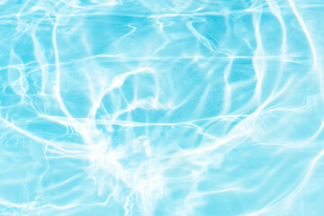 Blue water with ripples on the surface. Defocus blurred transparent blue colored clear calm water surface texture with splashes and bubbles. Water waves with shining pattern texture background.