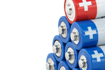 Close-up of stacked AA batteries showing the positive terminals