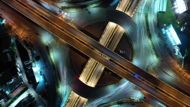 Expressway top view, Road traffic an important infrastructure, car traffic transportation above intersection road in city night sky aerial view cityscape of advanced innovation, financial technology