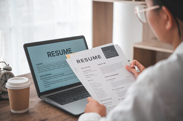 People are reviewing job applications before filling out their resume on the job application form in order to apply for a job at a company.