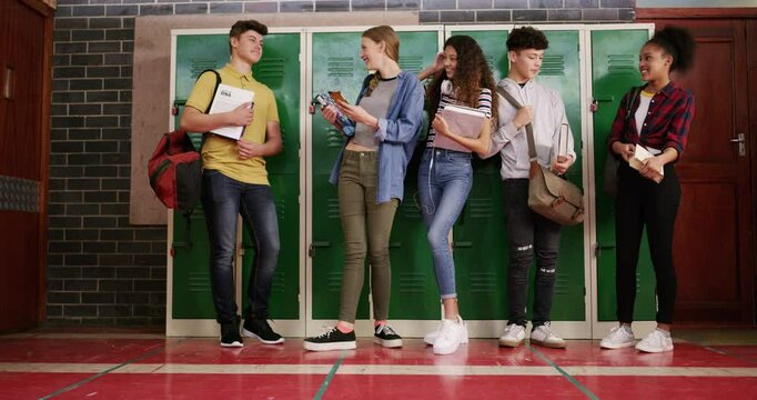 Group of students, high school locker and education, learning or knowledge with books, phone and ready for class. Happy youth, teenager or friends laughing and talking of social media or study ideas