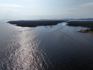 Aerial view of Lake Huron's northern shore, with a large island across a narrow channel from the mainland